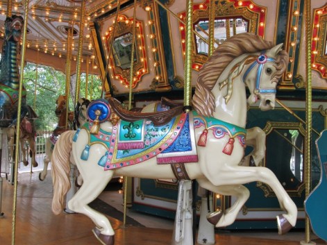 white carnival horse on a lighted merry-go-round